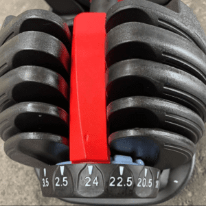Strength Training Equipment- (300*300)- Adjustable dumbbell with view of one side of the weight plate area with dial visible
