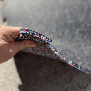 Commercial Standard Exercise mat- (300*300) Image showing a hand lifting a Flooring Mat from the corner revealing side layer