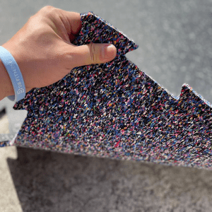 Commercial Standard Exercise mat- (300*300) Image showing a hand lifting a Flooring Mat from the corner revealing the bottom side of the mat