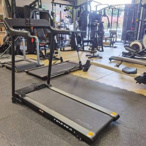 Cardio Equipment- (300*300) image- Rear profile view of the Foldable Treadmill DB-2001 in a gym with various other equipment in frame