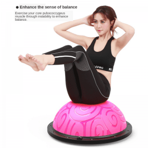Strength Training Equipment- (300*300)- Man with gym outfit performing mountain climbers using a Black Bosu Ball (inverted) in an indoor setting with panoramic windows with a small pond and tall hedge visible outside