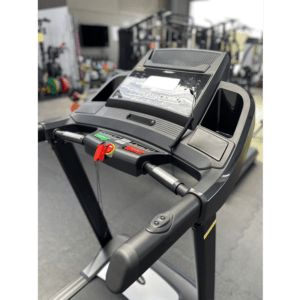 Cardio Equipment- (300*300) image- Cropped profile view of the Foldable Treadmill DB-2003 in a Gym with console, handlebar and vertical frame in view along with other equipment out of focus