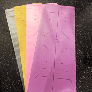 Yoga Product- All four colour variants of the Premium Yoga Mat placed overlapping one another but visible on the sides, "Deep Space Gray","Cork", "Cherry Blossom Pink", "Mandala Purple"