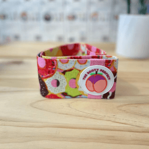 Weightlifting Accessories- (300*300)- Folded Pink Hip Resistance Band placed vertically on a table