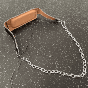 Weight Lifting Gear- Rear profile view of the Weight lifting belt with chain, placed on gym floor