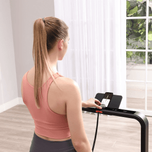 Cardio Equipment- Woman adjusting the settings of the WalkingPad x21 treadmill