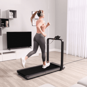 Cardio Equipment- Woman running on the WalkingPad x21 Double-Fold Treadmill in an indoor setting wearing white over-ear headphones