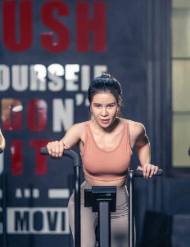 Benefits of air bike – group working out on exercise bike