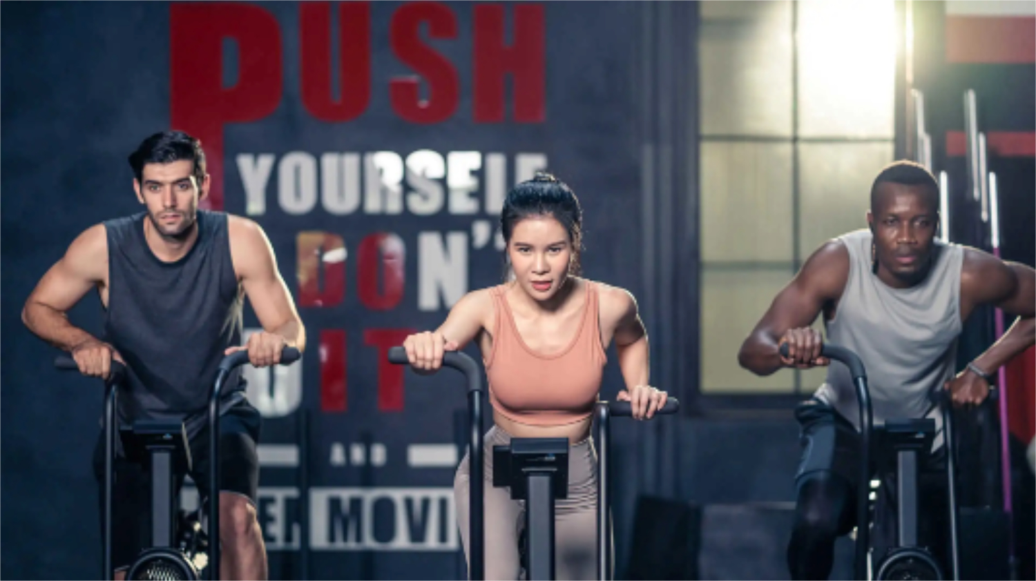 Benefits of air bike – group working out on exercise bike