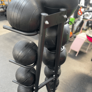 Back view of medicine ball stand with balls in gym